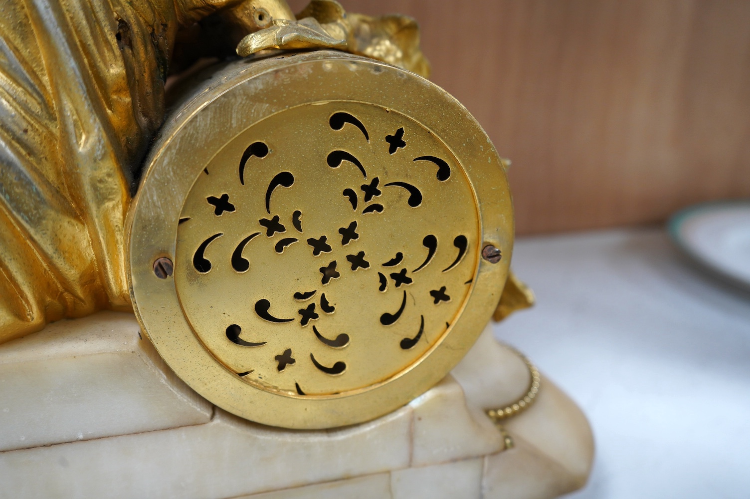 A 19th century white marble mantel clock with enamel dial, surmounted with a gilt spelter figure, with key, 46cm wide. Condition - fair, untested